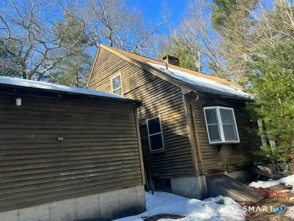 a view of house with a door and wooden fence