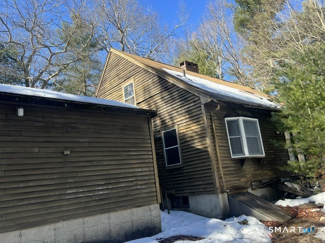 a view of house with a door and wooden fence