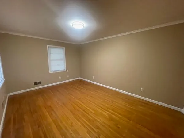 an empty room with a windows and closet