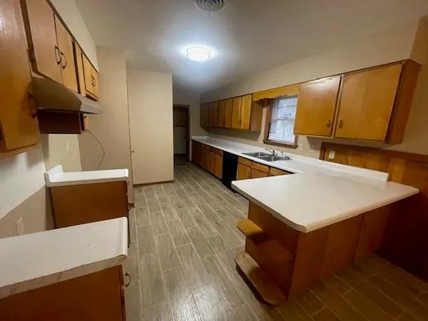 a kitchen with stainless steel appliances a stove a sink and a refrigerator