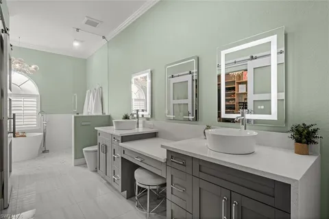a bathroom with a sink double vanity granite and a mirror