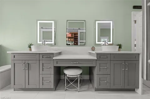 a spacious bathroom with a granite countertop sink a mirror and a toilet