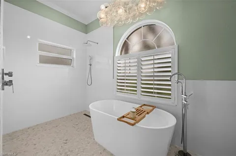 a bathroom with a sink a bathtub and a window