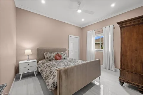 a bedroom with a large bed and a chandelier