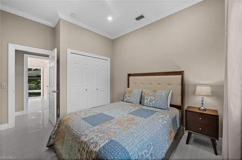 a bedroom with a bed and a night stand