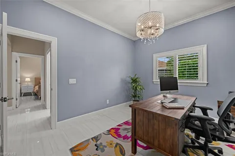 a room that has a bed and a chandelier