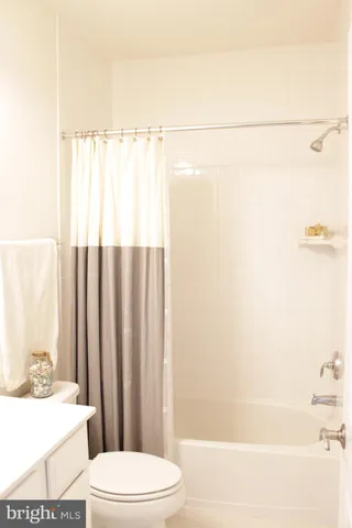 a bathroom with a sink a toilet and shower curtain