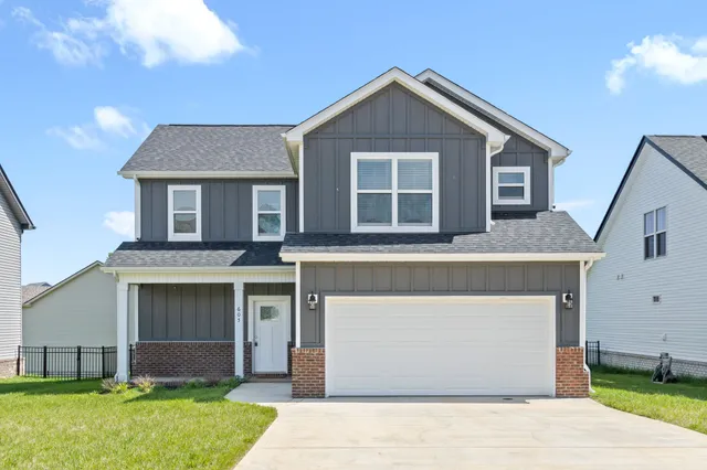 a front view of a house with a yard and garage