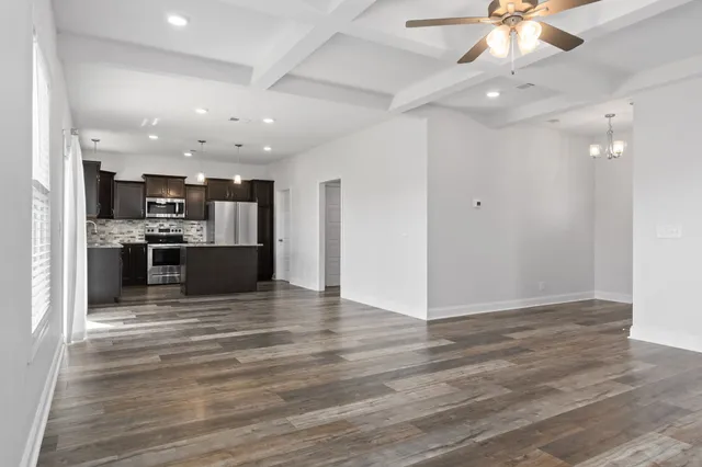 a view of a kitchen with a sink and a refrigerator