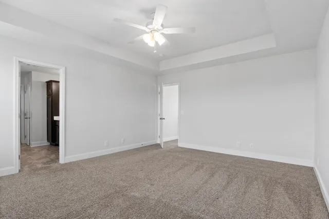 a view of an empty room with a ceiling fan