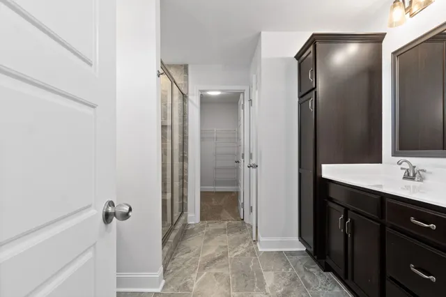 a bathroom with a double vanity sink and mirror