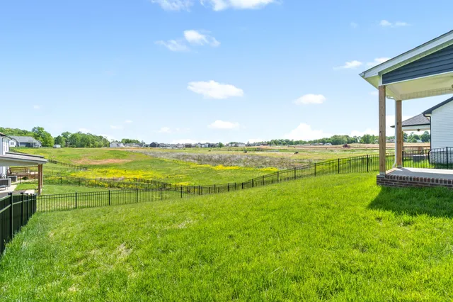 a view of house with backyard and porch