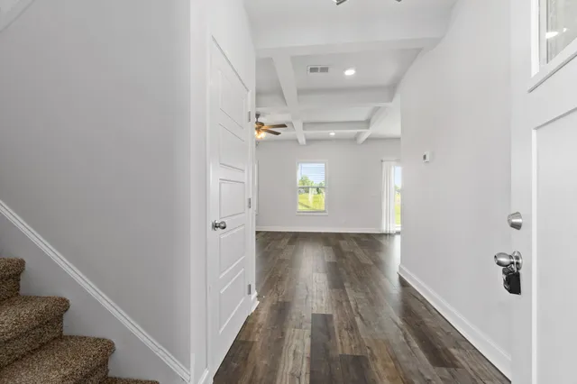 a view of a hallway view with wooden floor and staircase