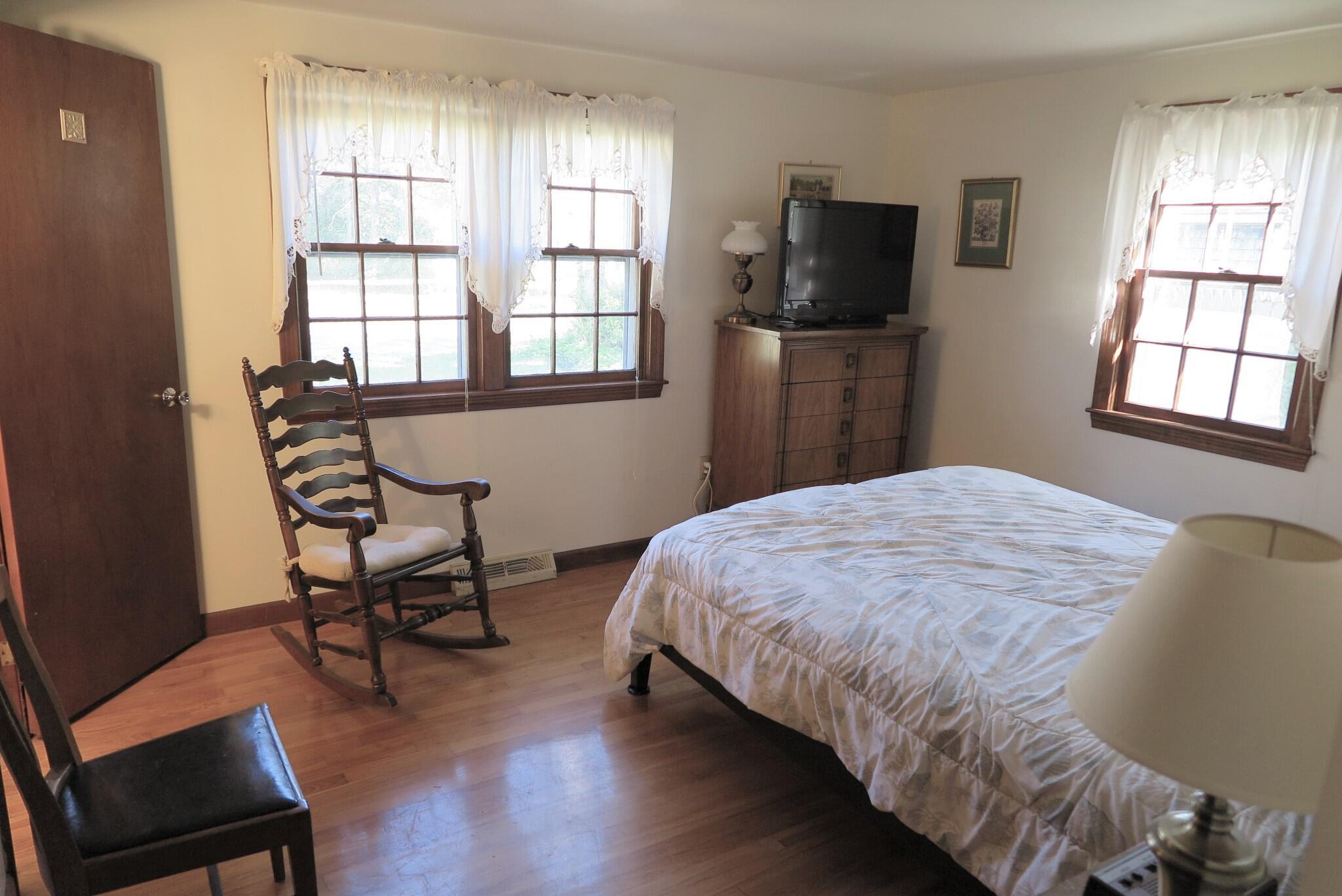 139 Captain Chase Road Dennis Port, MA 02639 - Photo 10 of 32 a bedroom with a bed tv and a window