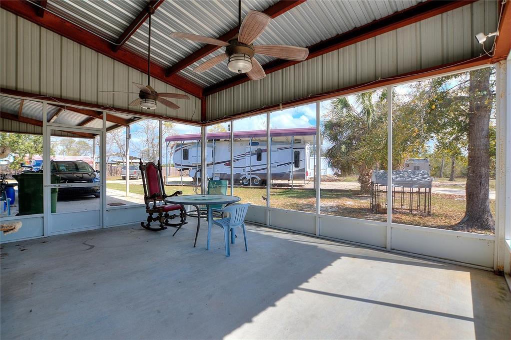 19550 Jody Morgan Road Perry, FL 32348 - Photo 45 of 79 a view of a patio with table and chairs potted plants with wooden floor
