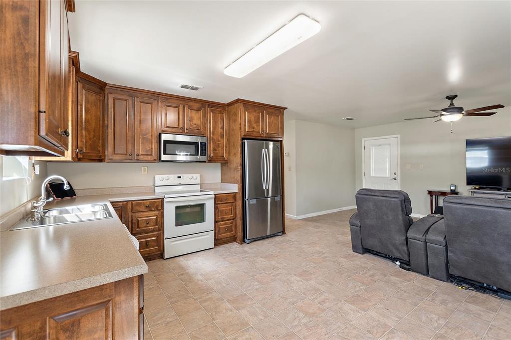 19550 Jody Morgan Road Perry, FL 32348 - Photo 61 of 79 a kitchen with stainless steel appliances granite countertop a refrigerator stove top oven a sink and dishwasher