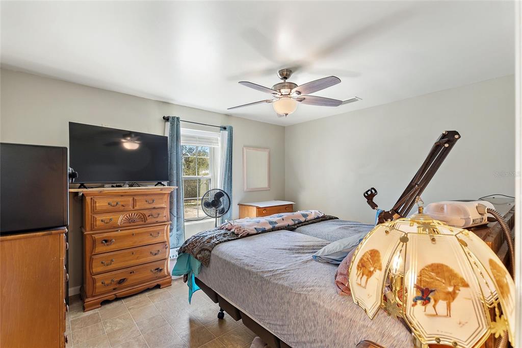 19550 Jody Morgan Road Perry, FL 32348 - Photo 69 of 79 a bedroom with a bed and a flat screen tv