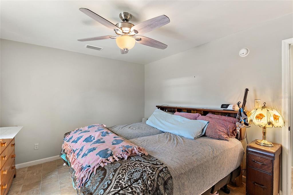 19550 Jody Morgan Road Perry, FL 32348 - Photo 70 of 79 a bedroom with a bed and a chandelier