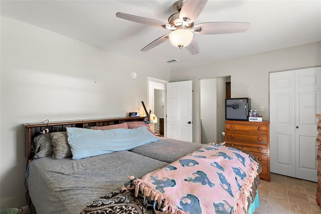 19550 Jody Morgan Road Perry, FL 32348 - Photo 71 of 79 a bedroom with a bed and a chandelier