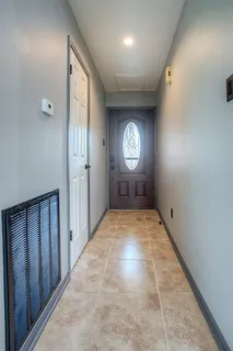 a view of a livingroom with wooden floor and a ceiling fan