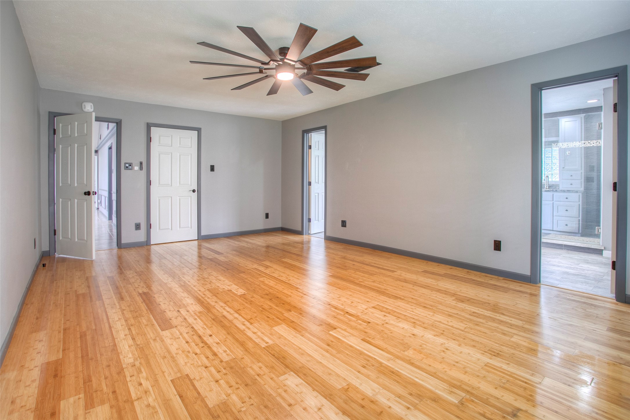 479 Cherry Hills Drive Huntsville, TX 77340 - Photo 29 of 49 a view of a livingroom with wooden floor and a ceiling fan