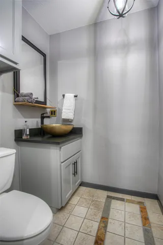 a bathroom with a toilet a sink and a mirror