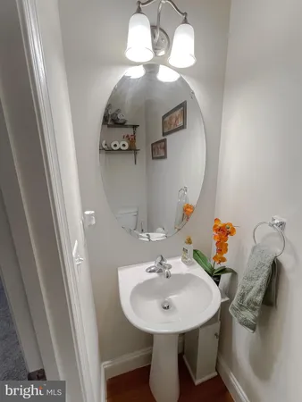 a bathroom with a sink a mirror and vanity