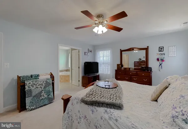 a bedroom with furniture and a large mirror