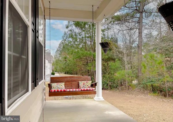 a view of a glass door and porch with seating space