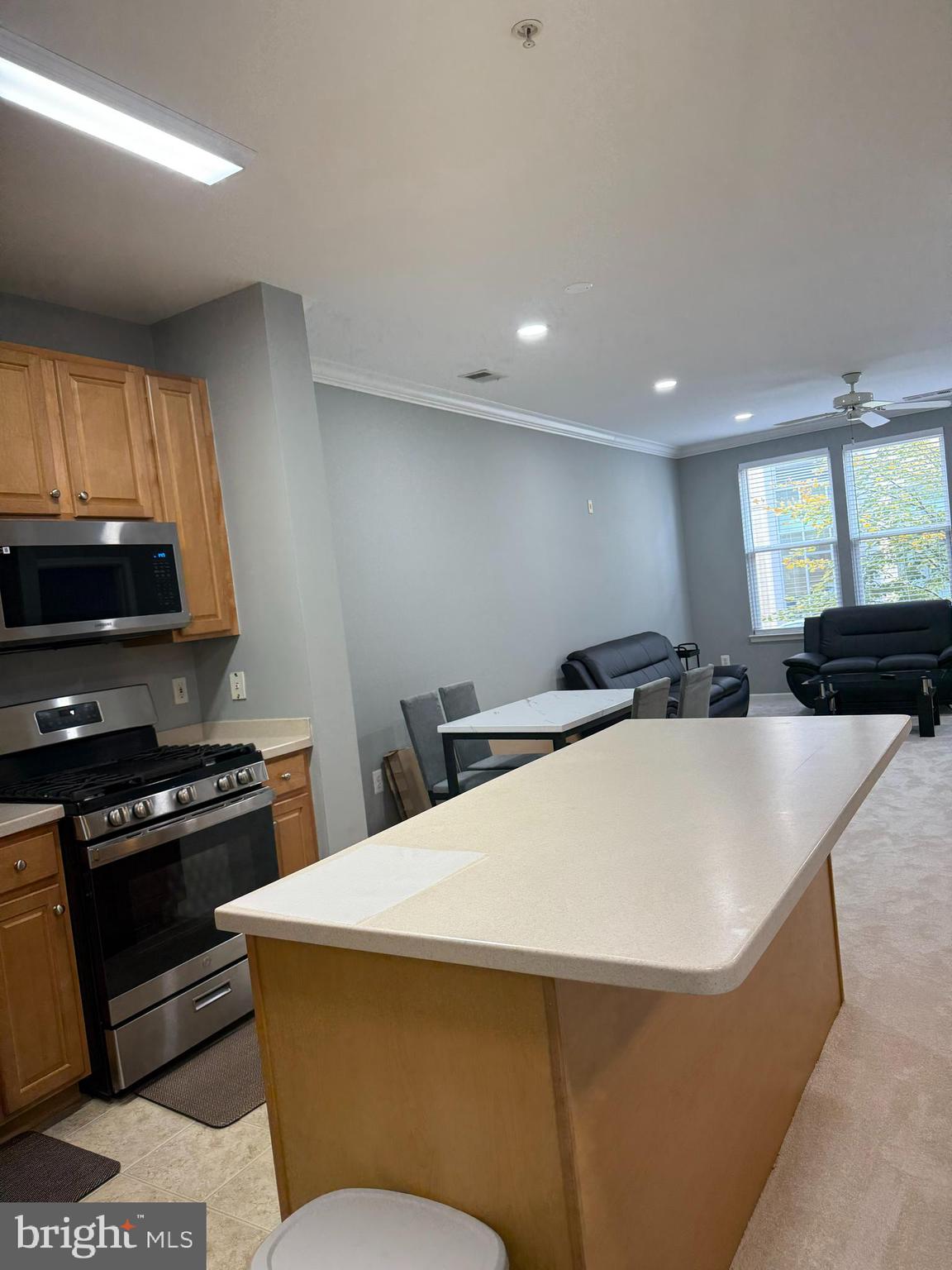 12001 Market Street, Unit 171 Reston, VA 20190 - Photo 4 of 10 a kitchen with stainless steel appliances a stove a sink a microwave a refrigerator and cabinets