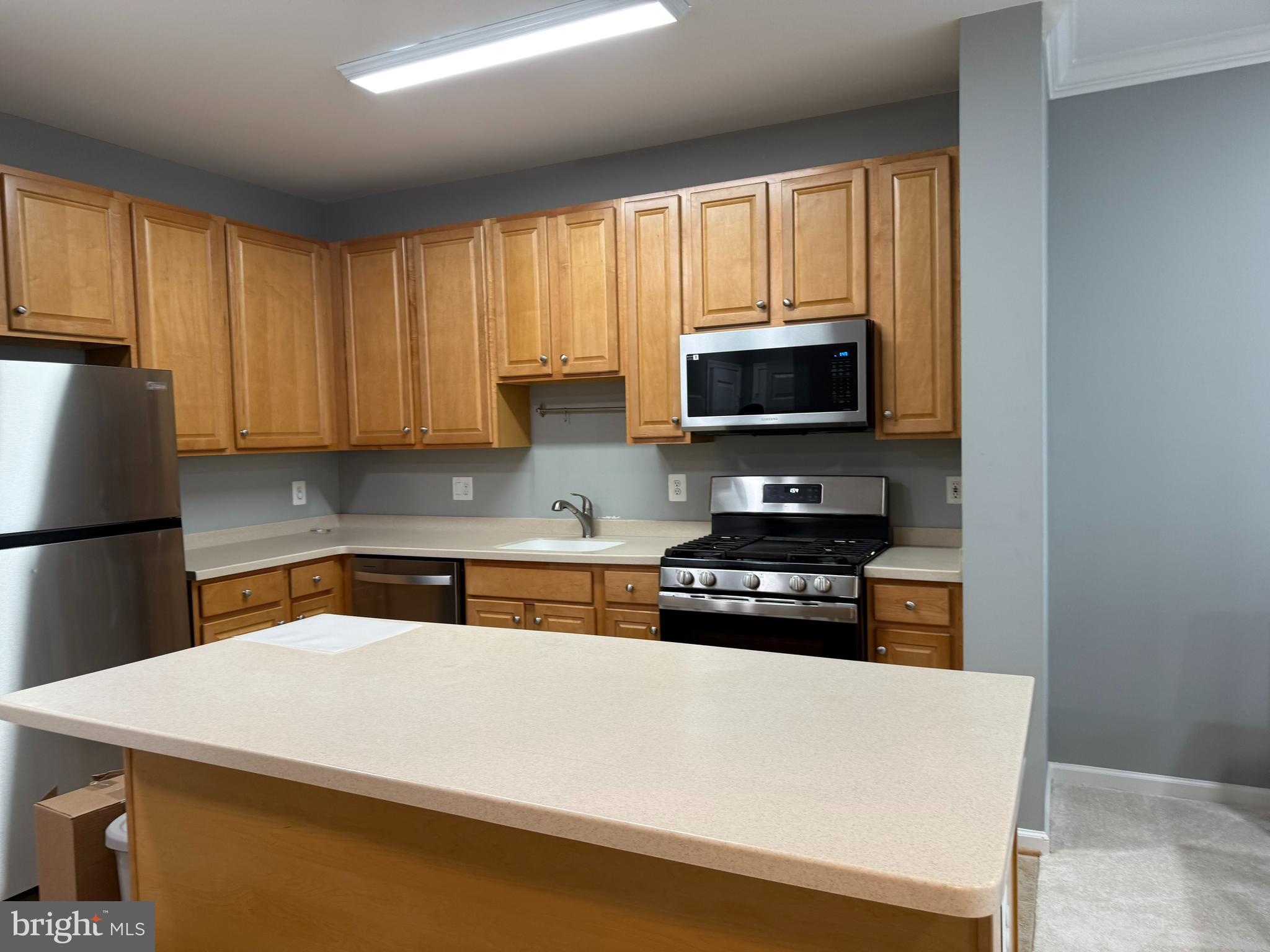 12001 Market Street, Unit 171 Reston, VA 20190 - Photo 5 of 10 a kitchen with a appliances a sink and a cabinets