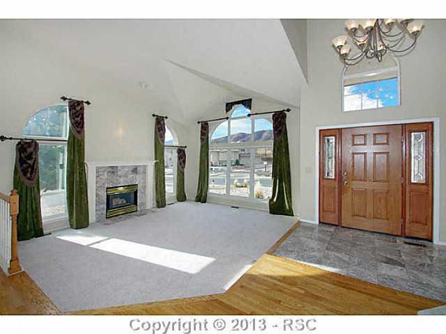 5905 Wilson Road Colorado Springs, CO 80919 - Photo 3 of 25 Formal Living Room w/ Soaring Ceilings & Gas Fireplace