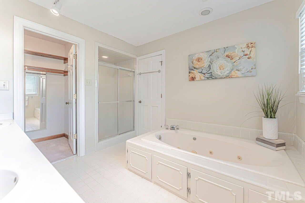 2616 Sawmill Road Raleigh, NC 27613 - Photo 15 of 18 a bathroom with a bathtub and a shower
