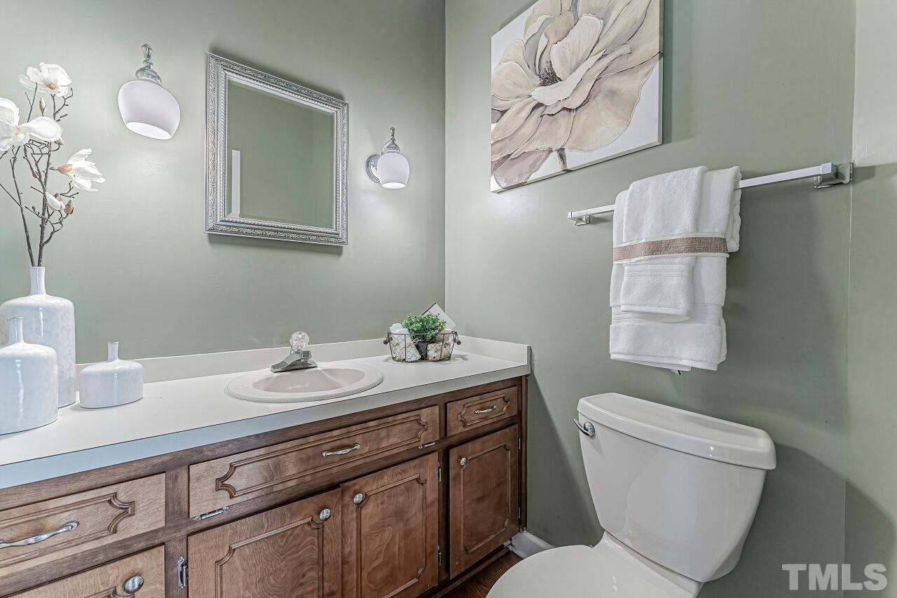 2616 Sawmill Road Raleigh, NC 27613 - Photo 5 of 18 a bathroom with a toilet a sink and mirror
