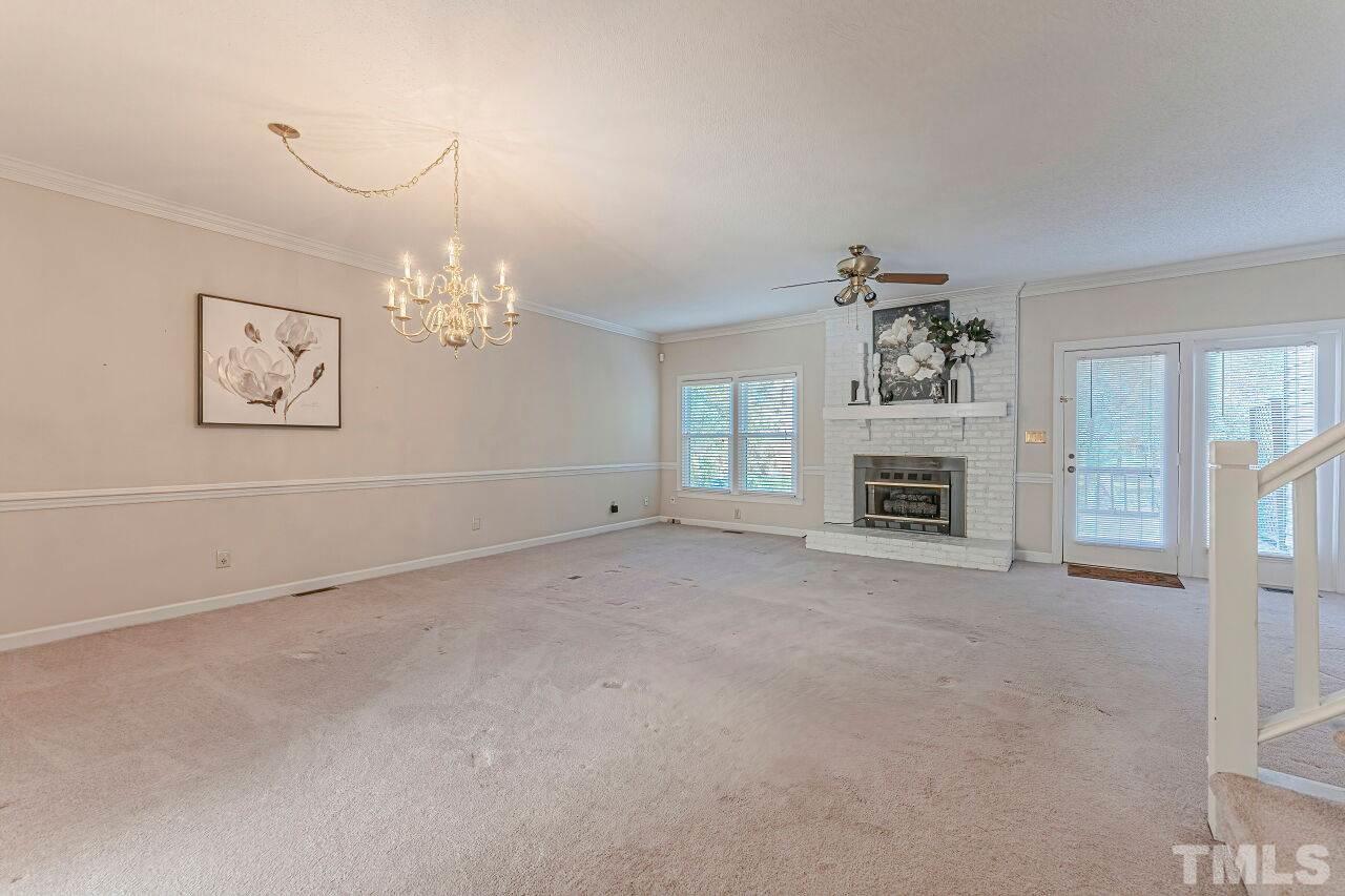 2616 Sawmill Road Raleigh, NC 27613 - Photo 6 of 18 a view of livingroom with furniture chandelier and window
