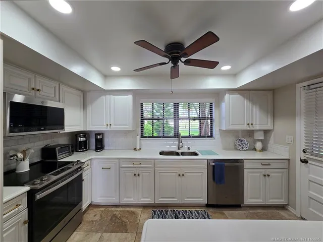 a kitchen that has a sink and a stove