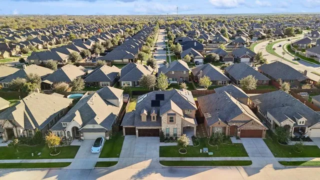 an aerial view of a house with a swimming pool