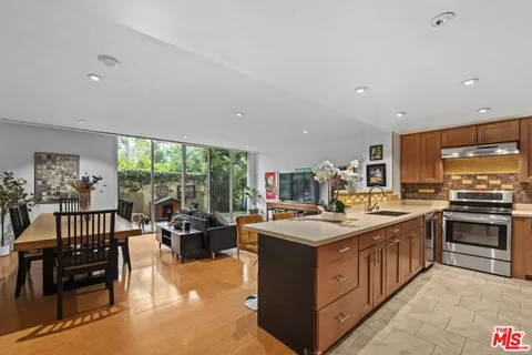 a kitchen with a stove a sink and a refrigerator