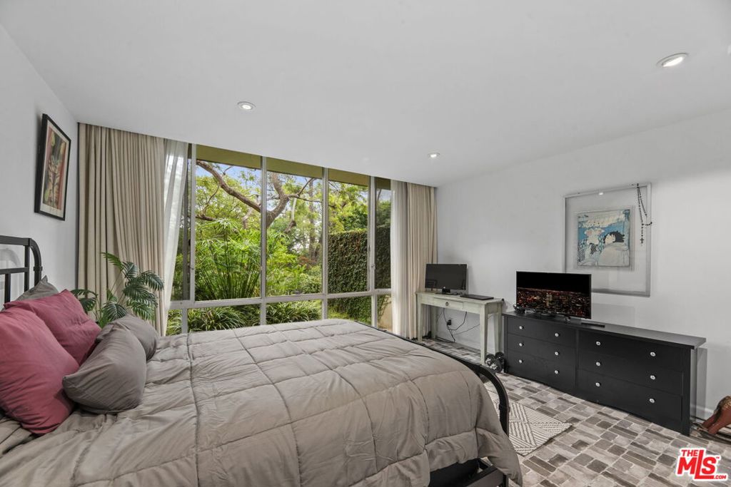 2160 Century Hill, Unit 104N Los Angeles, CA 90067 - Photo 10 of 26 a bedroom with a bed and large windows