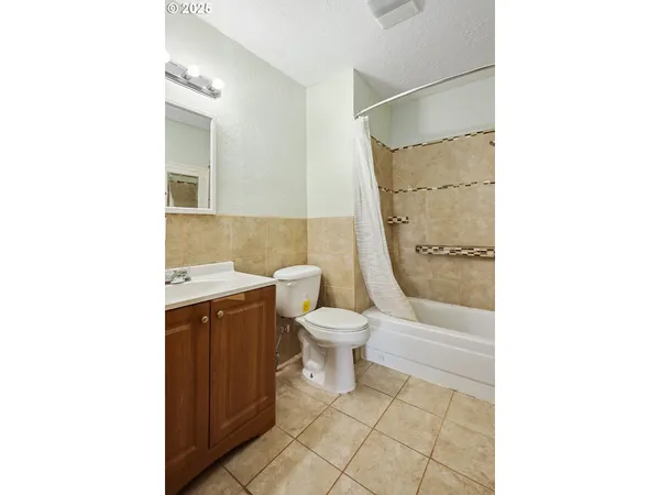 a bathroom with a toilet a sink and a shower