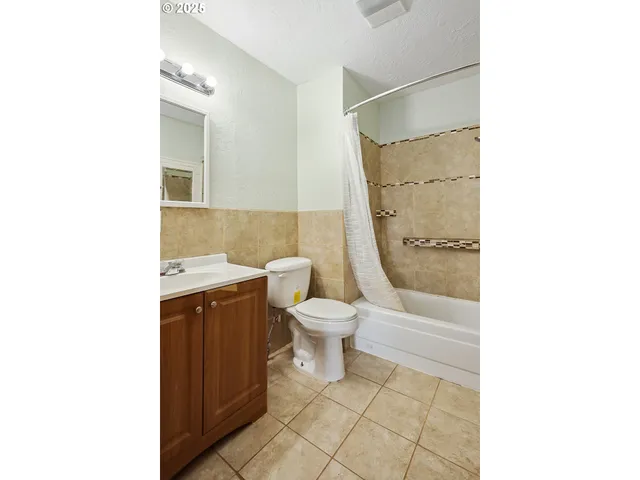a bathroom with a toilet a sink and a shower