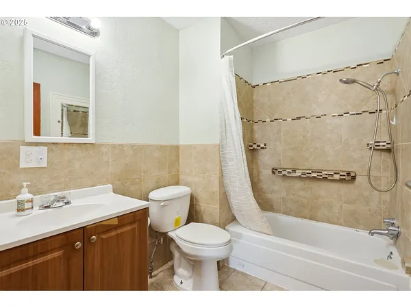 a bathroom with a sink toilet a shower and a mirror