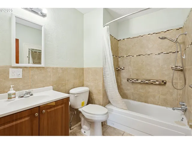a bathroom with a sink toilet a shower and a mirror