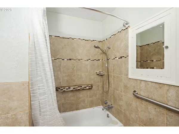 a bathroom with a shower and a sink