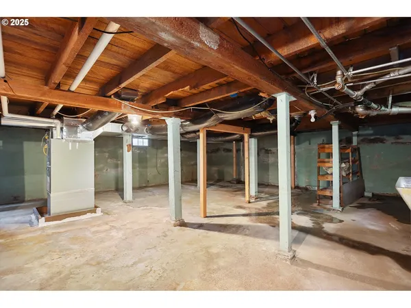 a view of a big room with wooden floor and windows