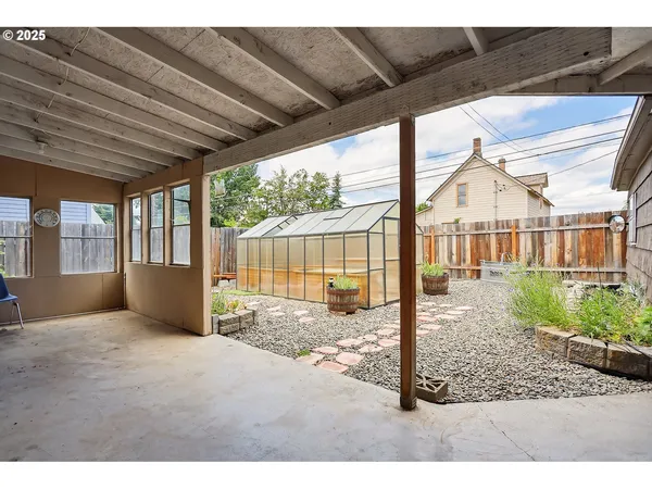 a backyard of a house with table and chairs