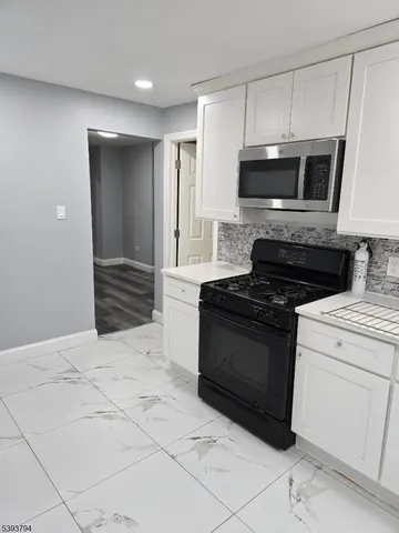 a kitchen with a stove and a microwave