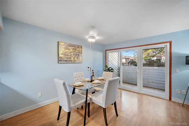 a dining room with furniture and wooden floor