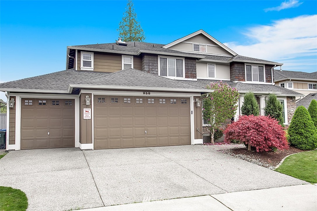 258 Lyons Place Northeast Renton, WA 98059 - Photo 1 of 25 a front view of a house with a garage