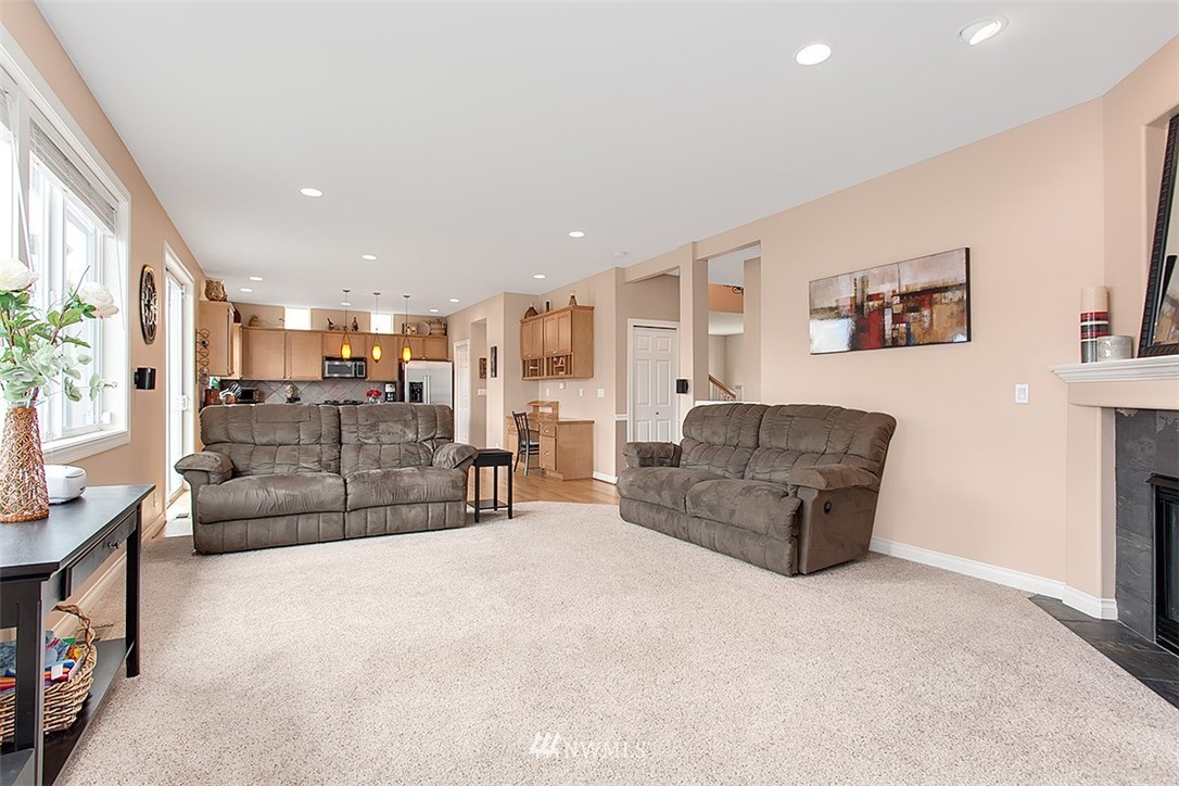 258 Lyons Place Northeast Renton, WA 98059 - Photo 12 of 25 a living room with furniture and a flat screen tv
